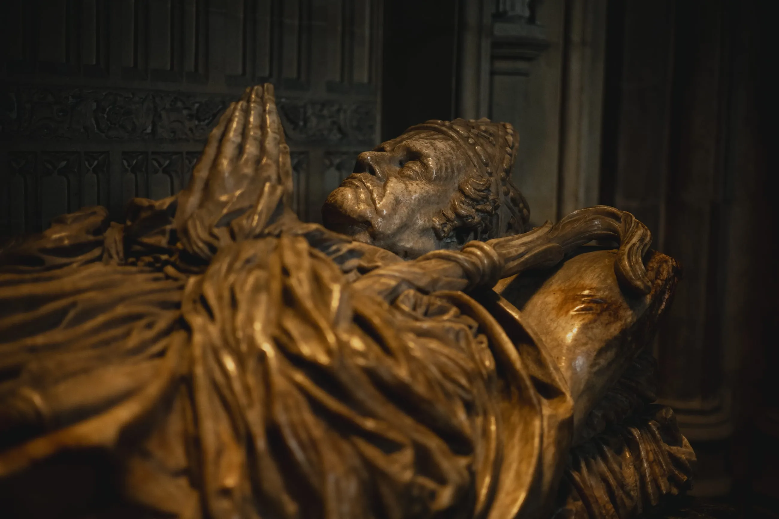 Bronze effigy with hands joined in prayer