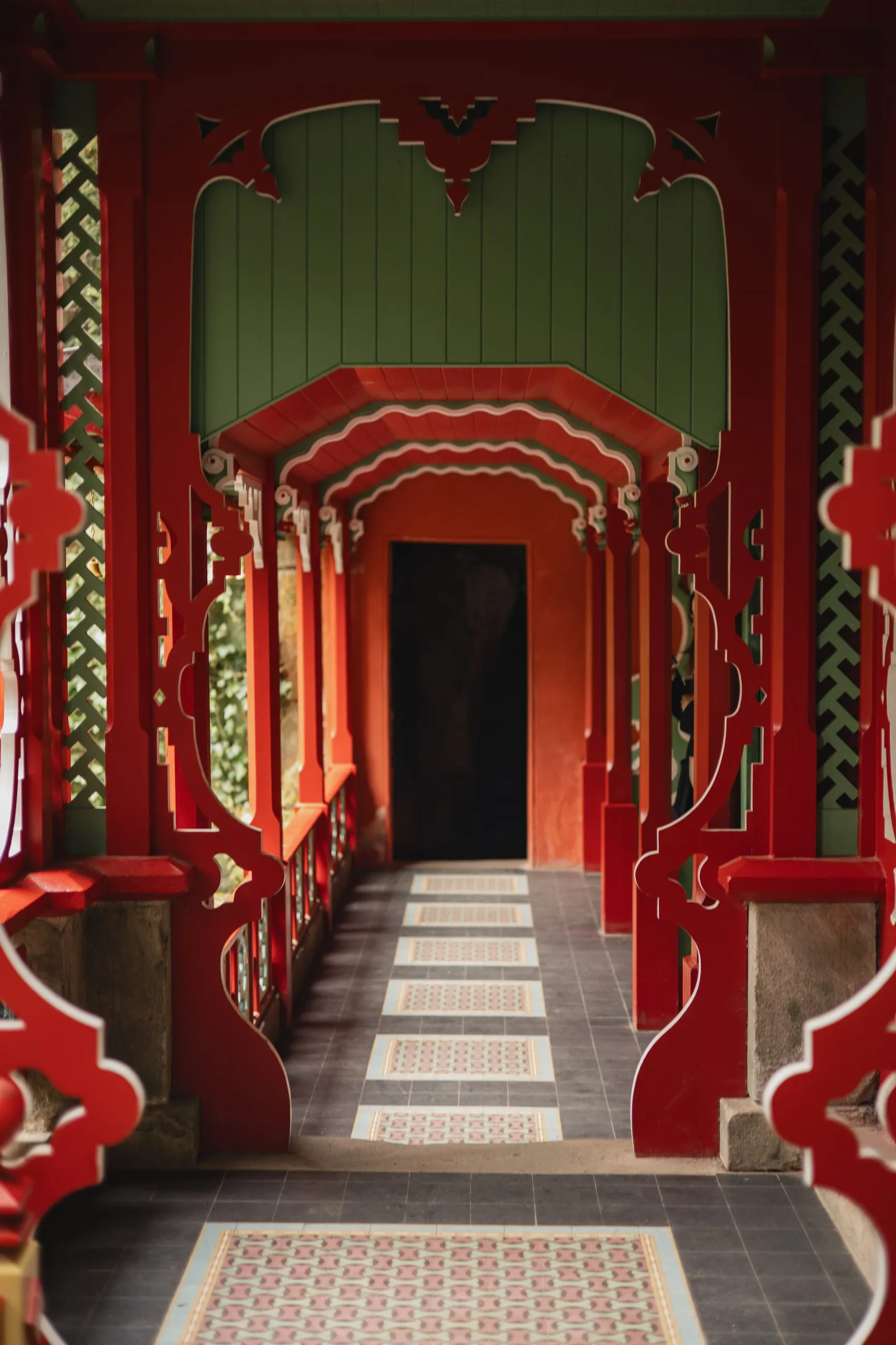 Red and green Chinese corridor leading into darkness