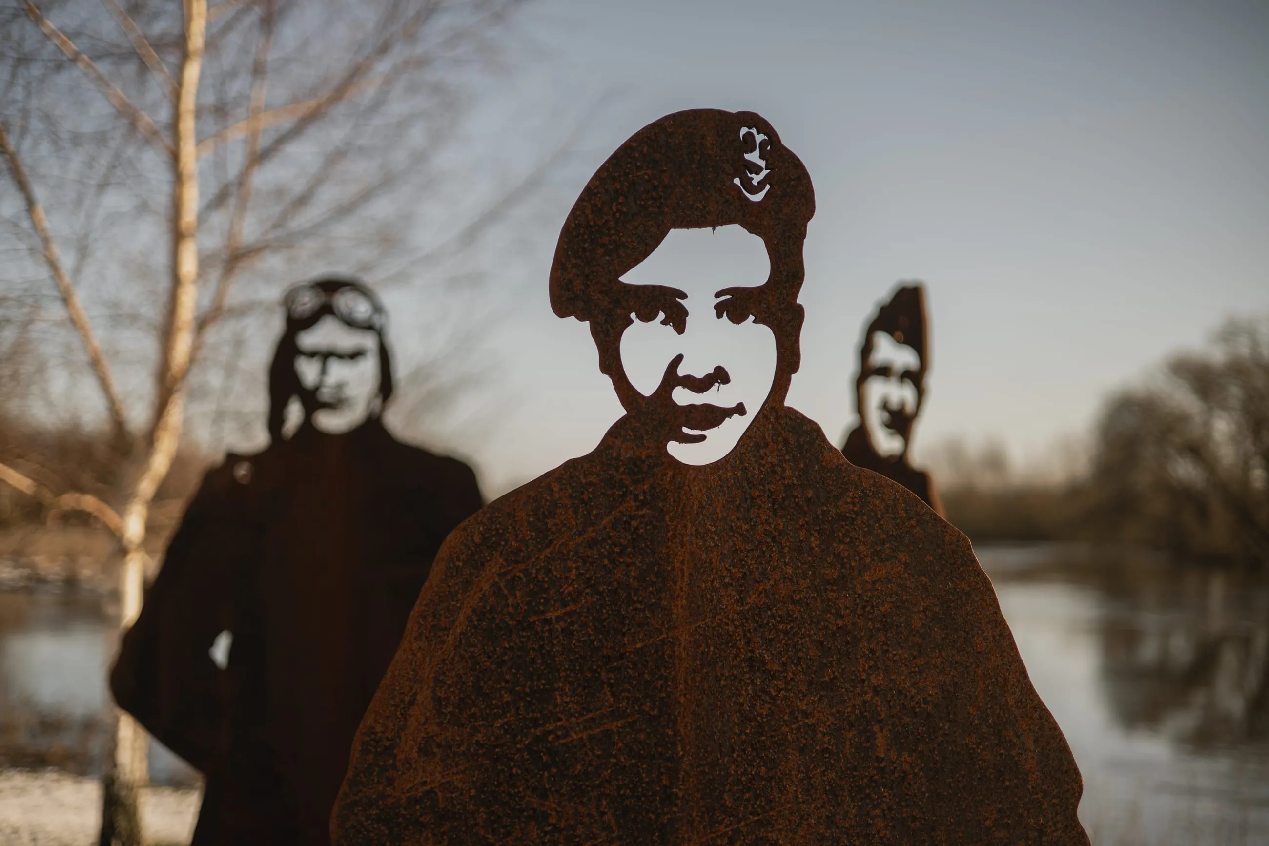 Rusted steel silhouettes of soldiers in berets