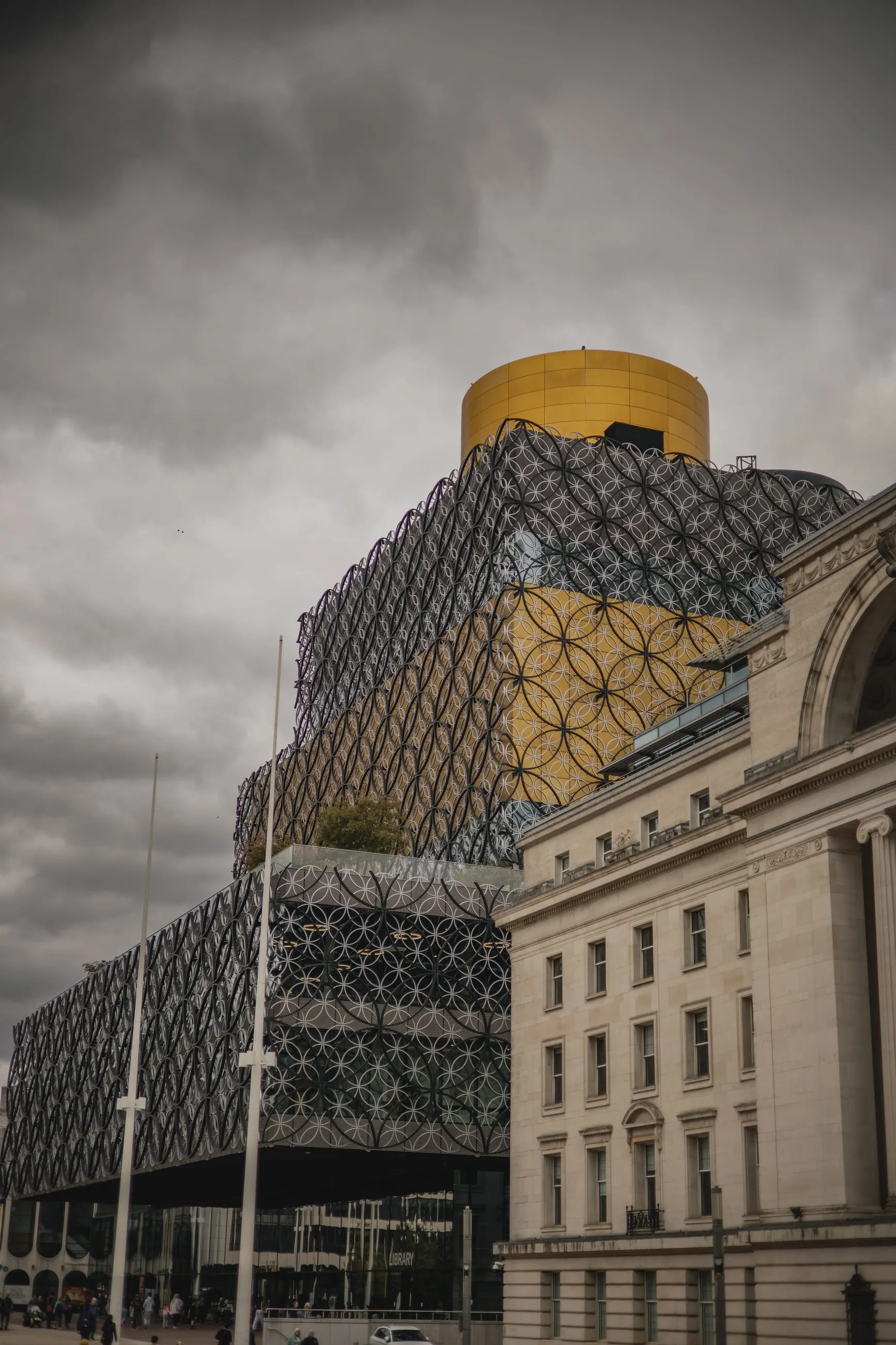 Library of Birmingham's gold rotunda under heavy cloud