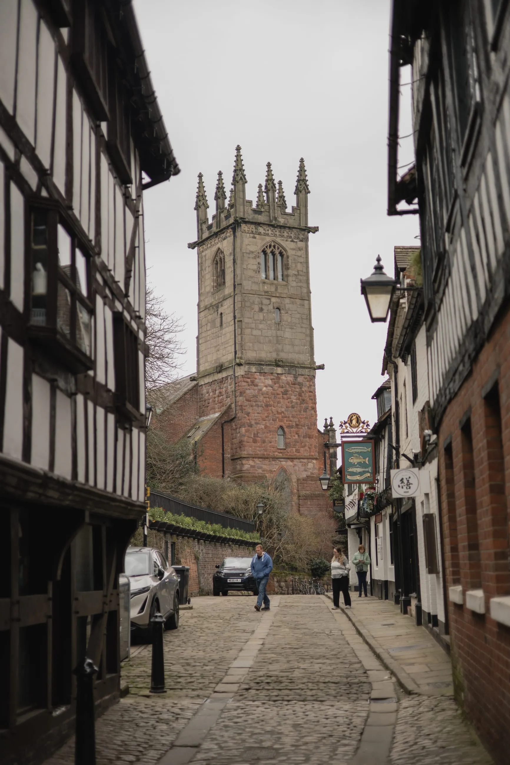 Half-timbered street leading up to a church tower