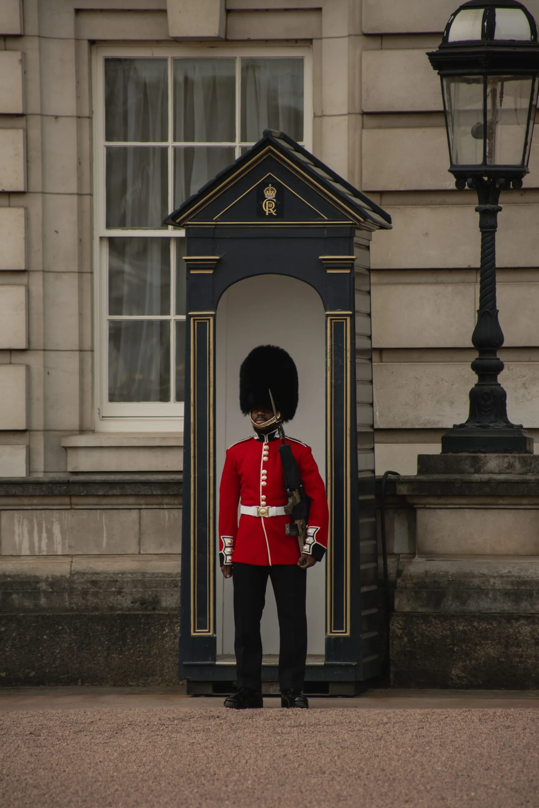 Guardsman in red tunic beside his sentry box