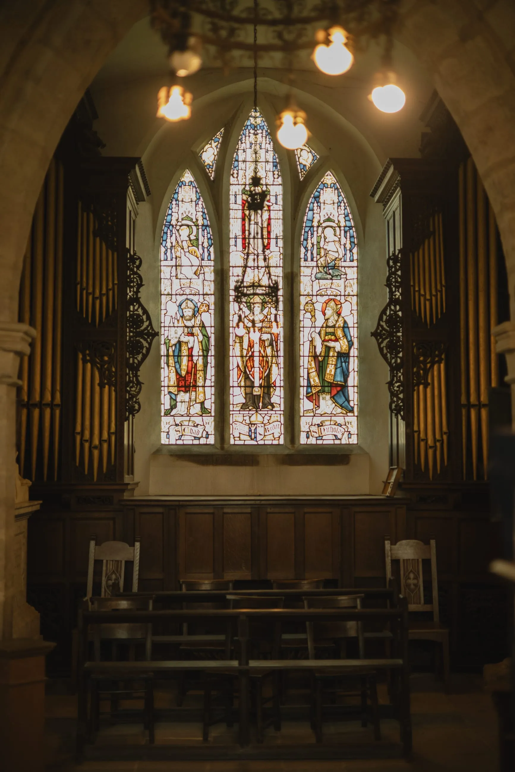 Church chancel lit by a stained-glass window