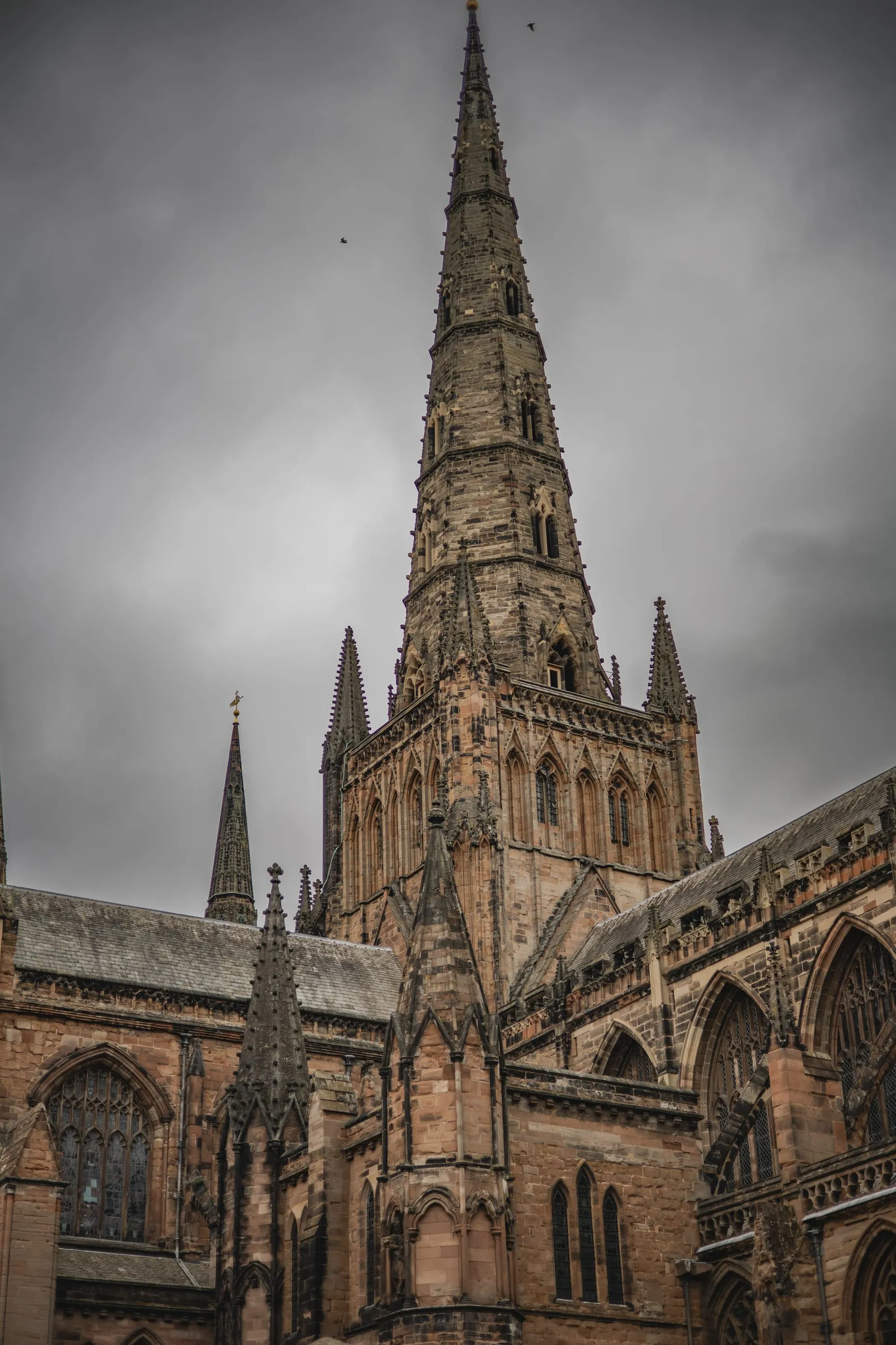 Cathedral spire under a heavy grey sky