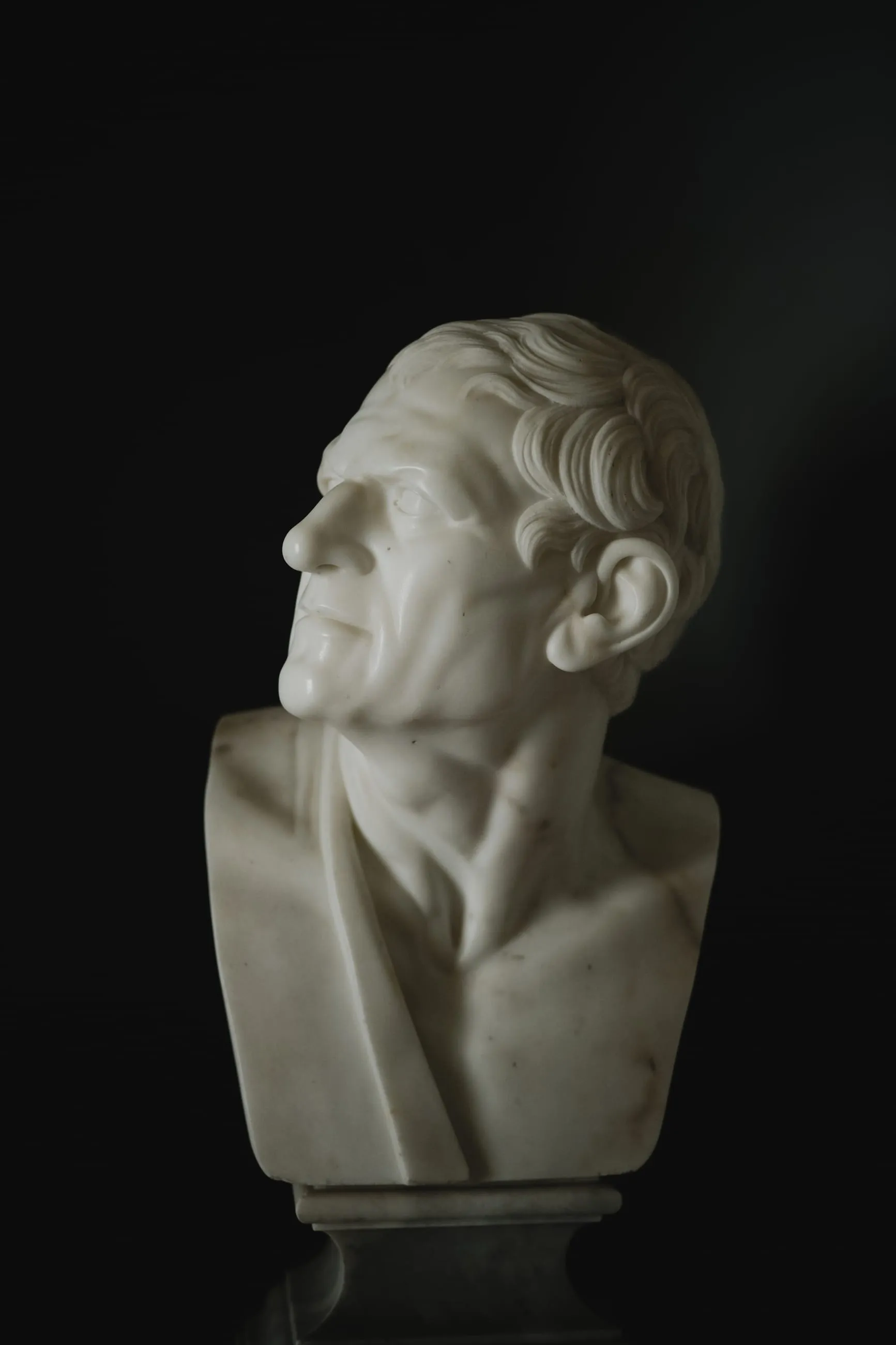 Marble bust lit against a black background