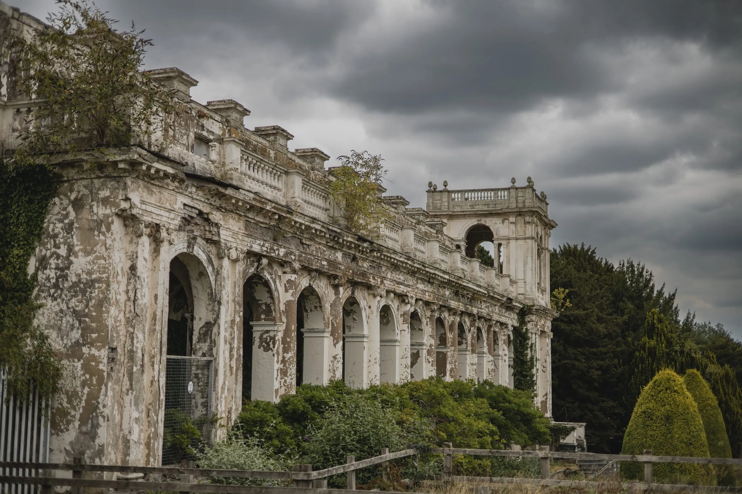 Crumbling Italianate arcade under a stormy sky