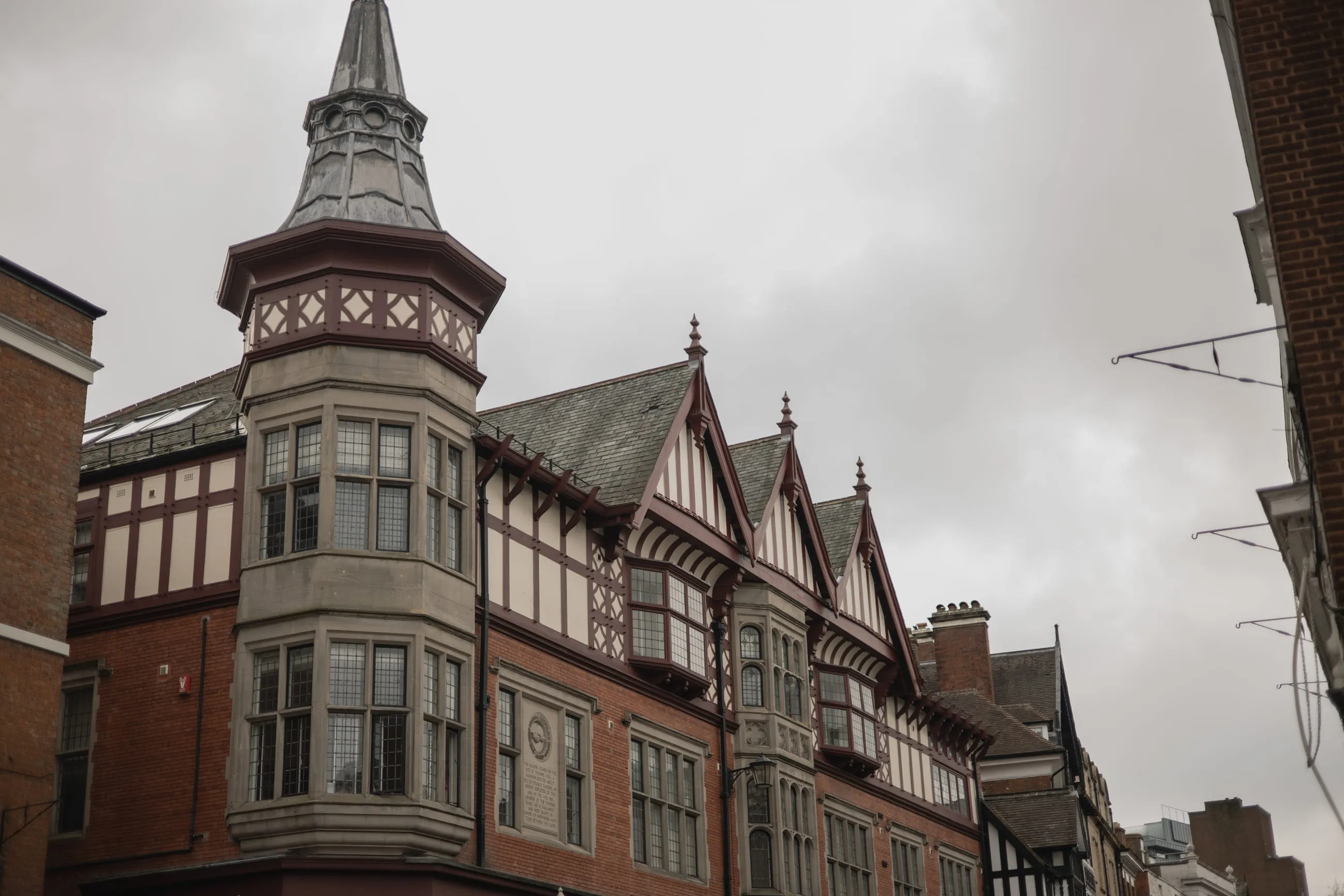 Victorian corner turret under a pale sky