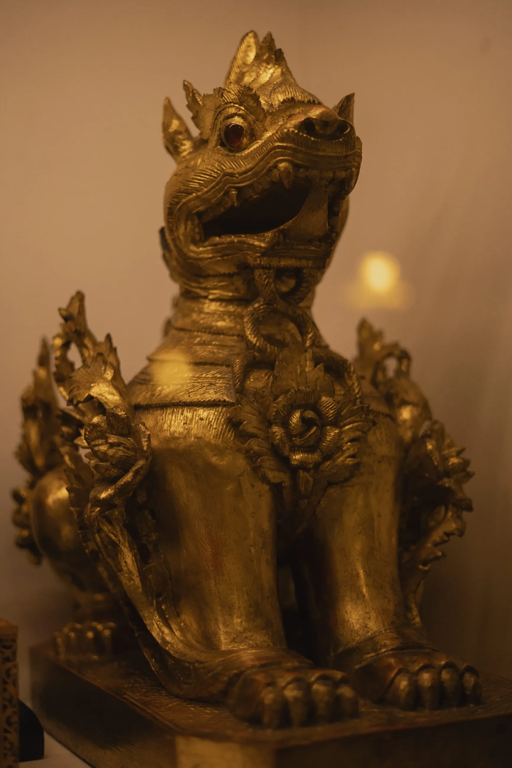 Gilded dragon figure glowing in low light