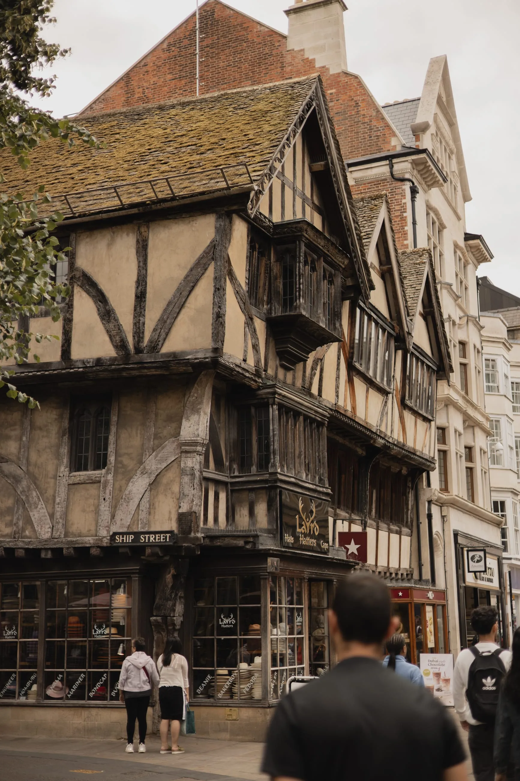Leaning half-timbered house on a busy corner