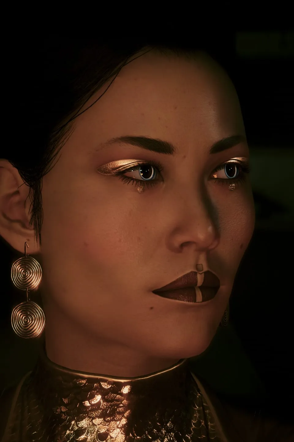 Close portrait, gold eyeshadow and earrings in low light
