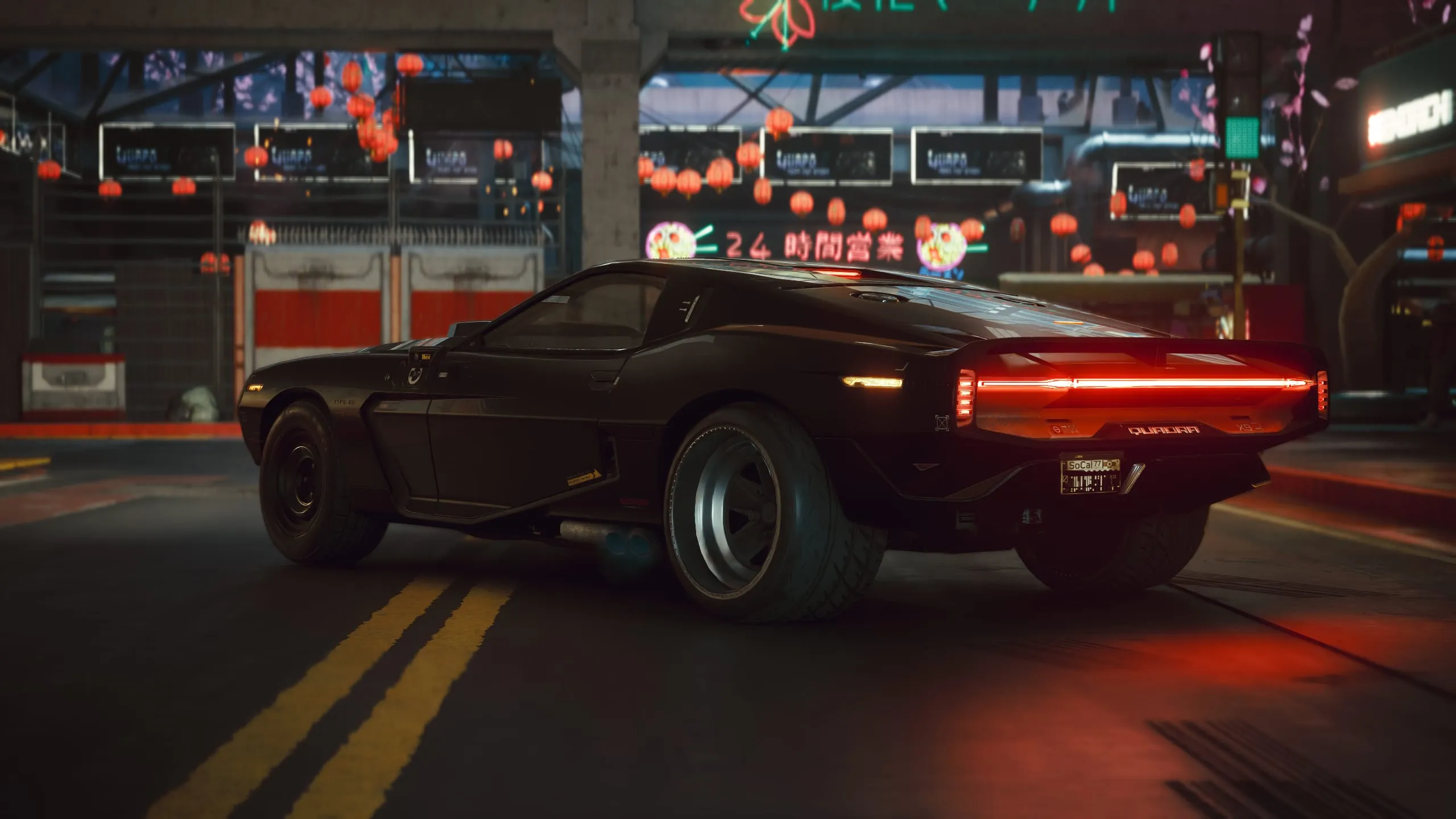 Black muscle car's red tail-light bar on a neon street