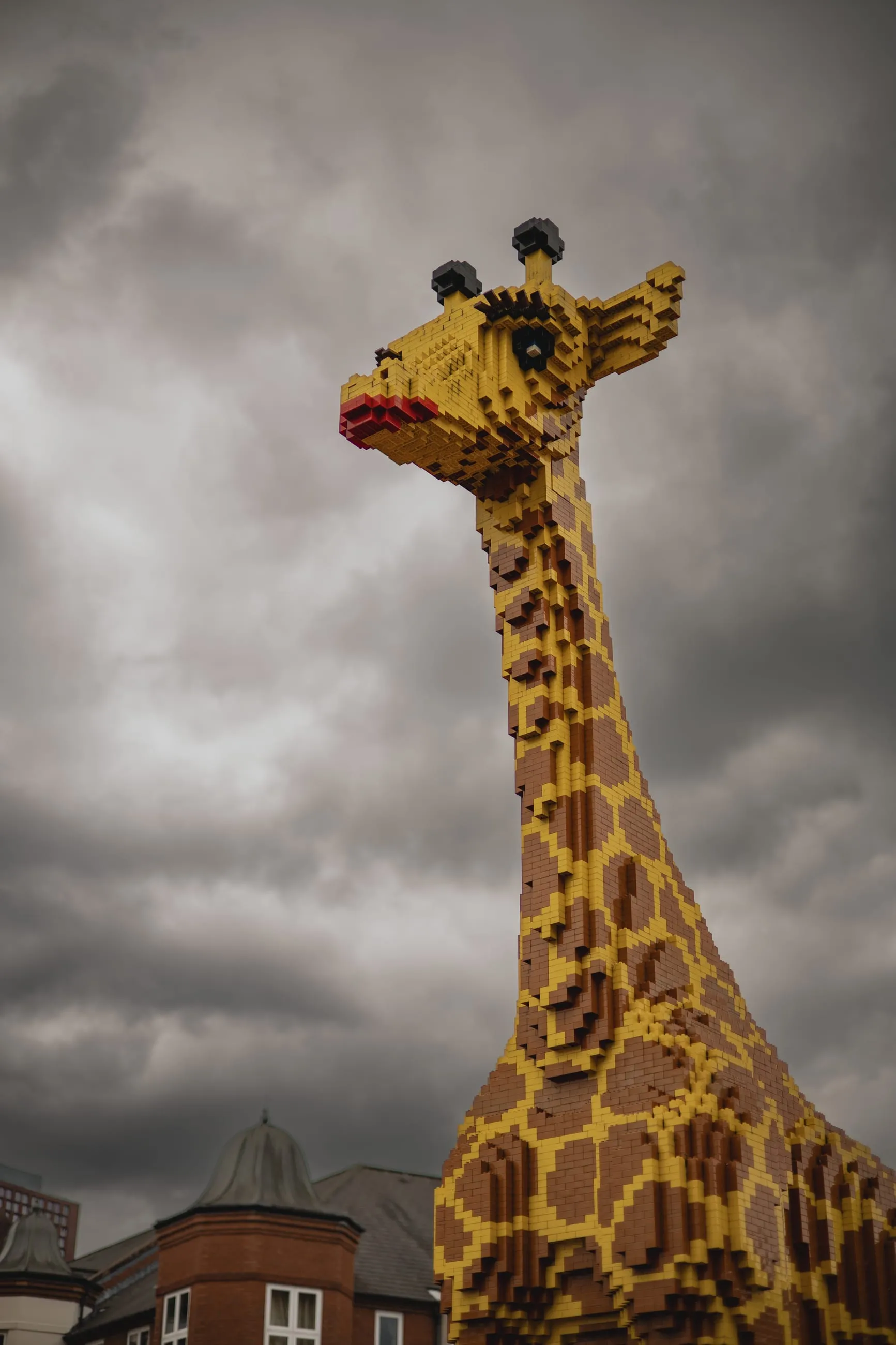 Giant model giraffe against a grey sky