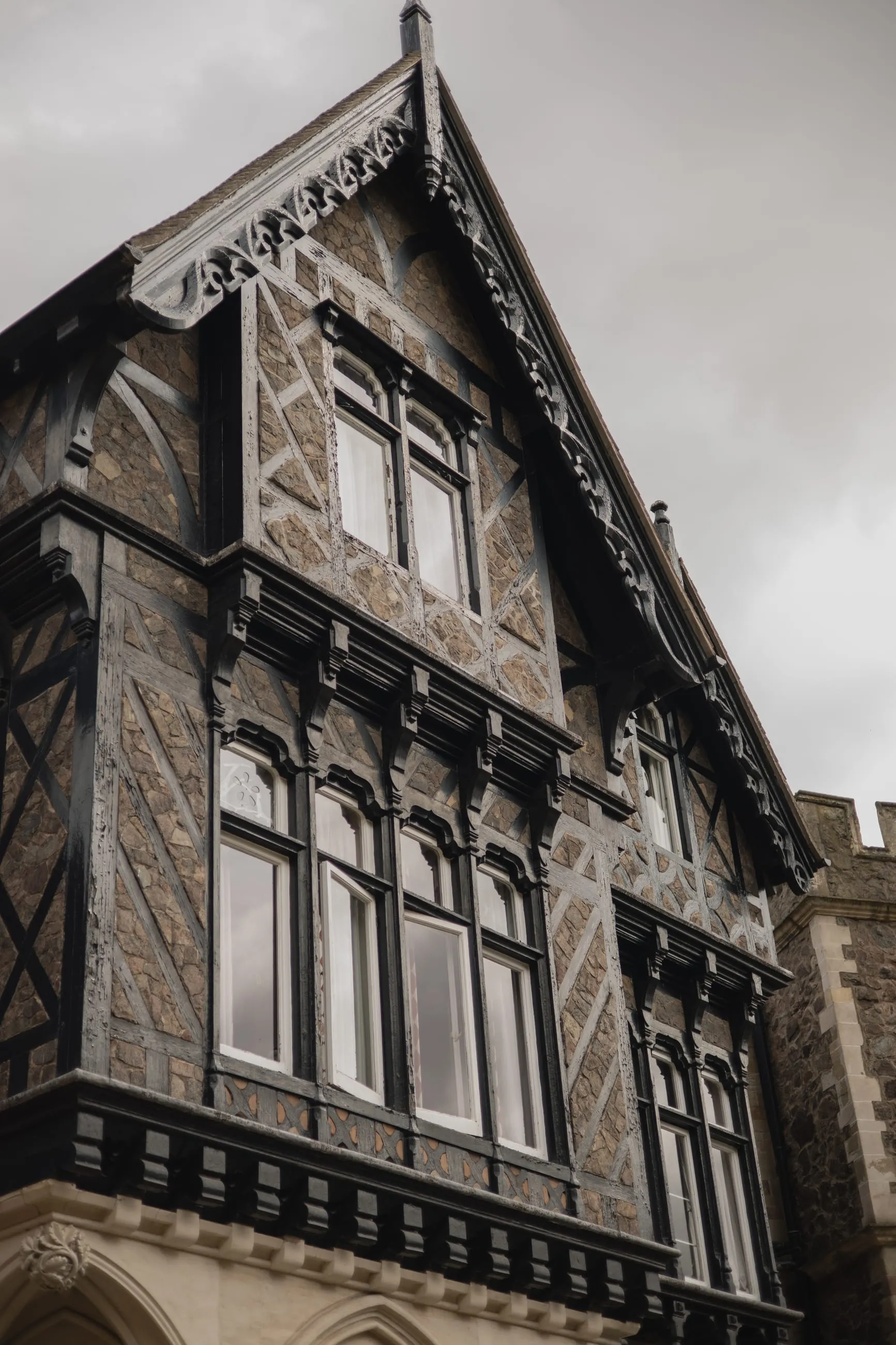 Dark gabled timber facade from below