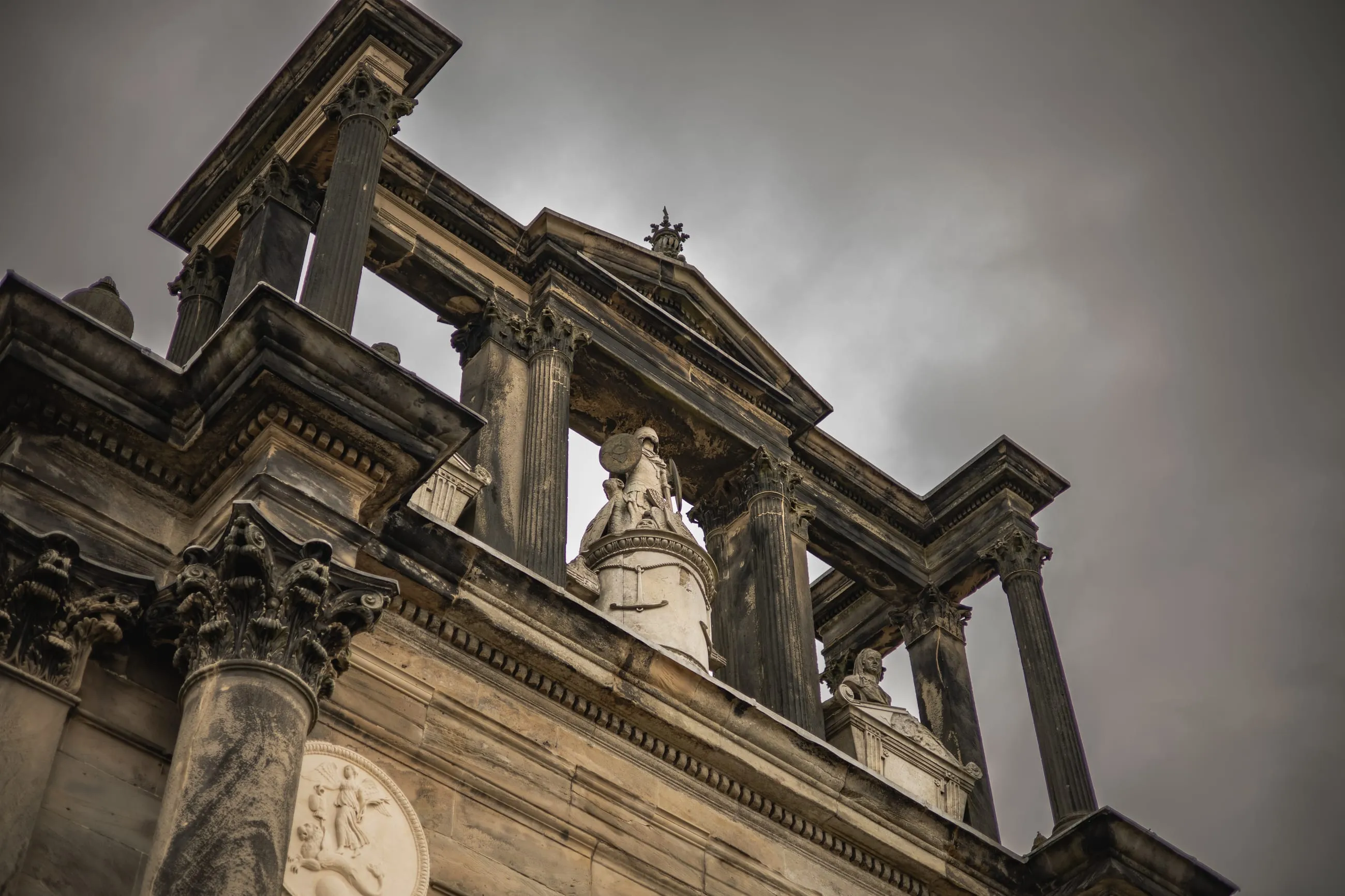 Triumphal arch from below under a heavy sky