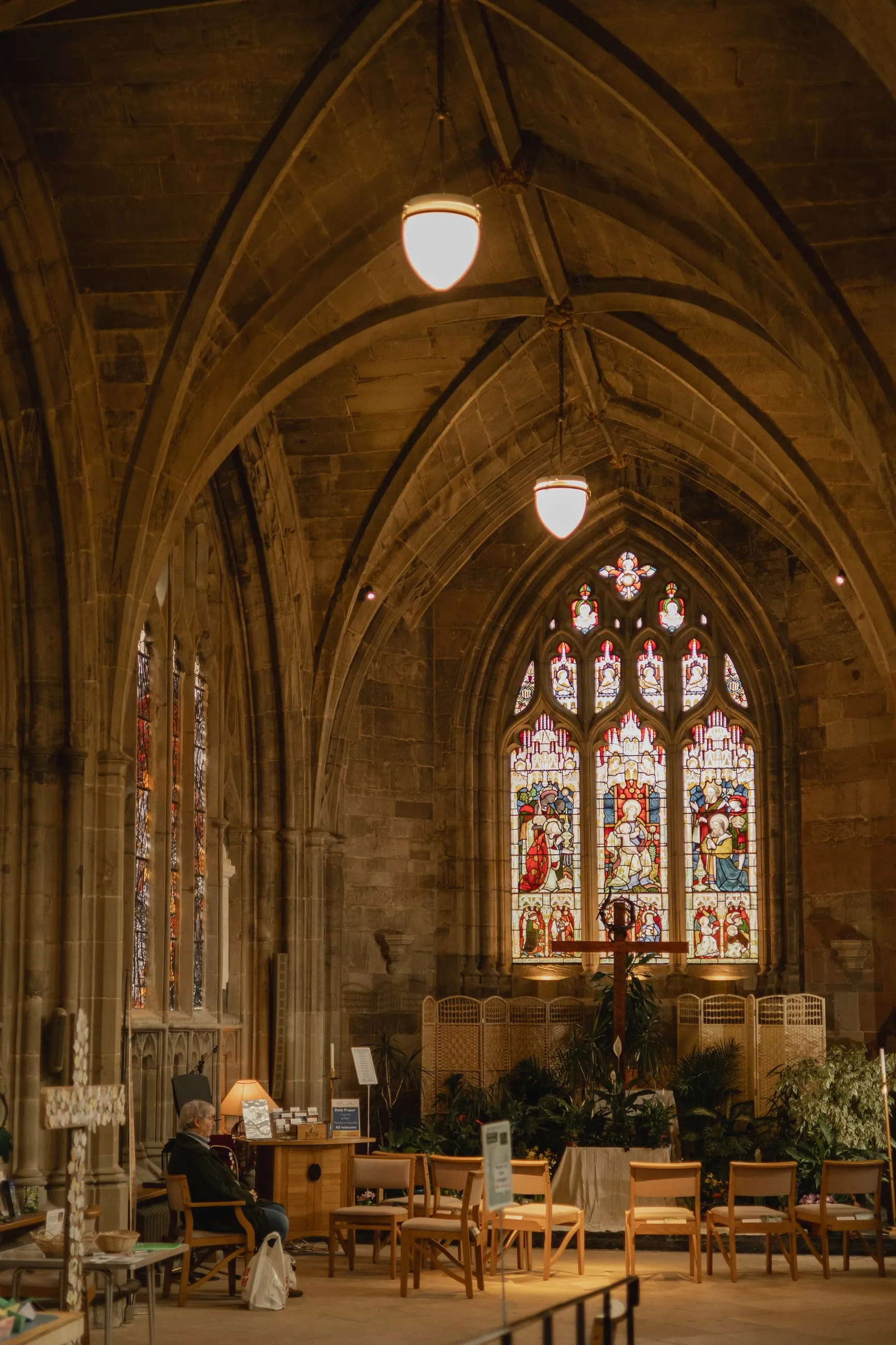 Side chapel with stained glass and hanging lamps