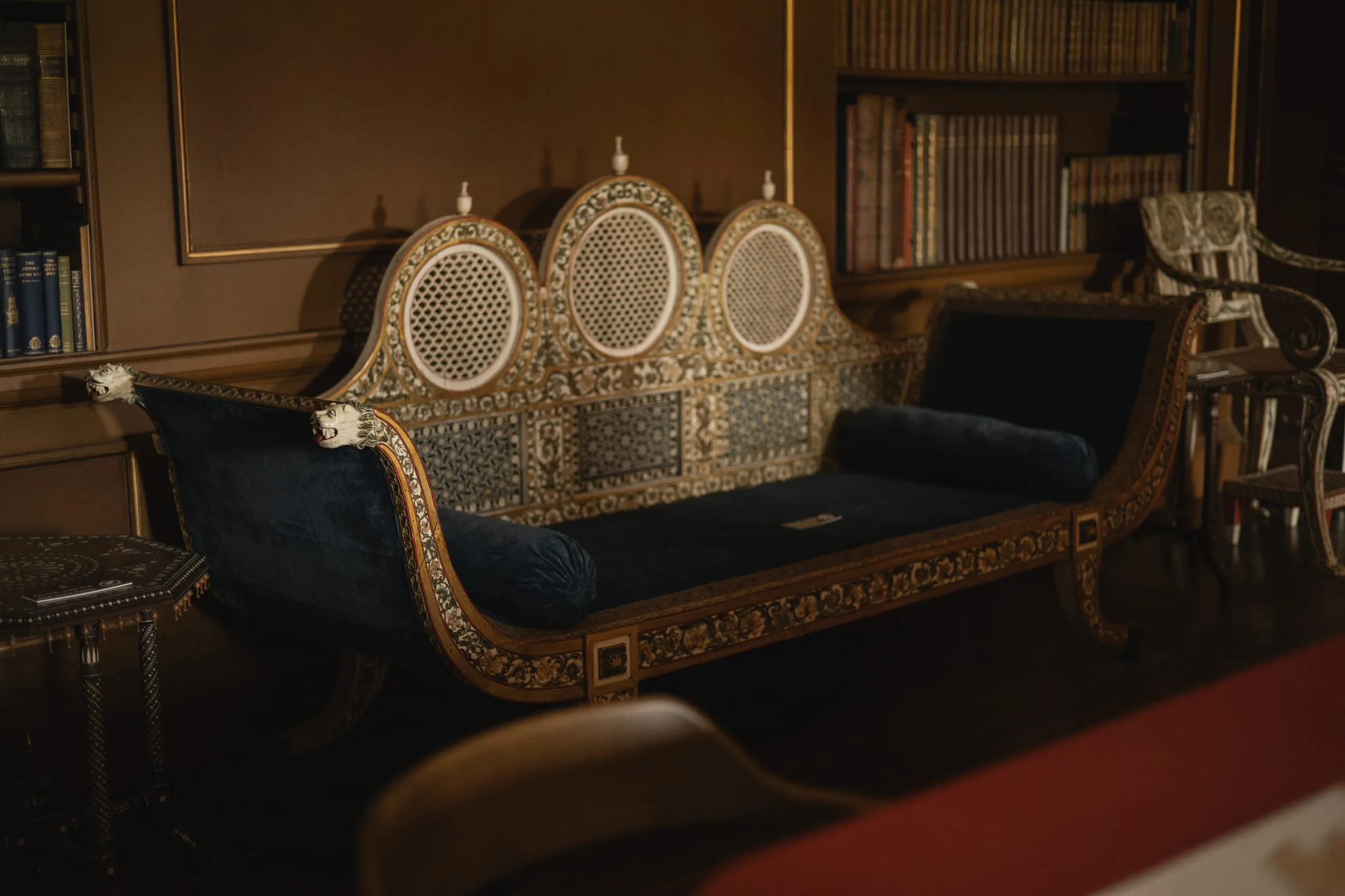 Carved ivory settee in a dark library