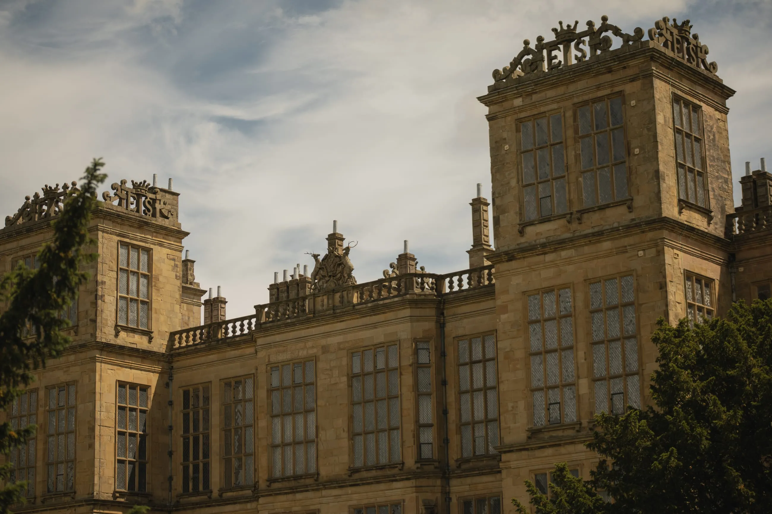 Hall's tall glass façade and roofline under cloud