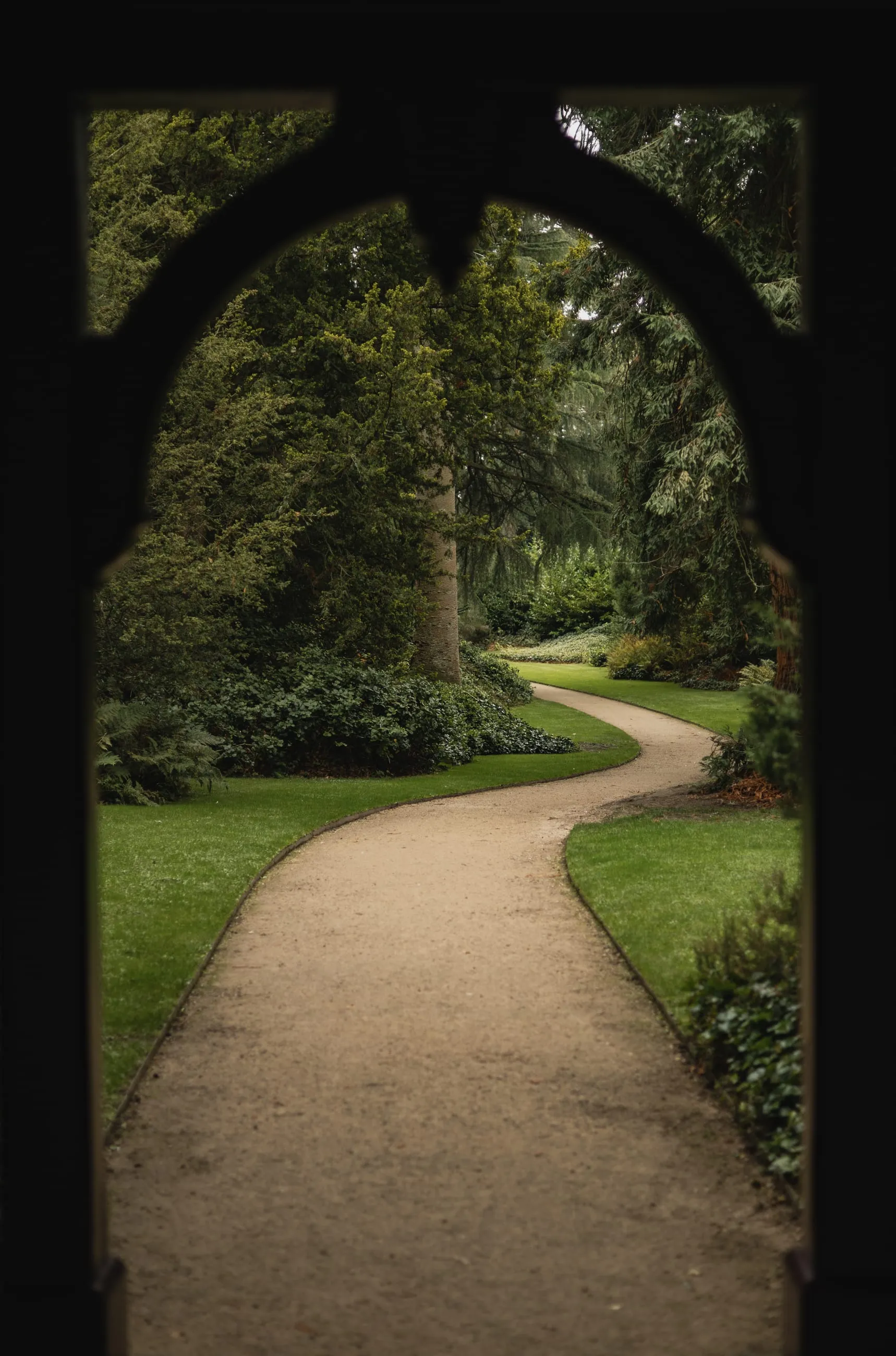 Winding path seen through a dark stone arch