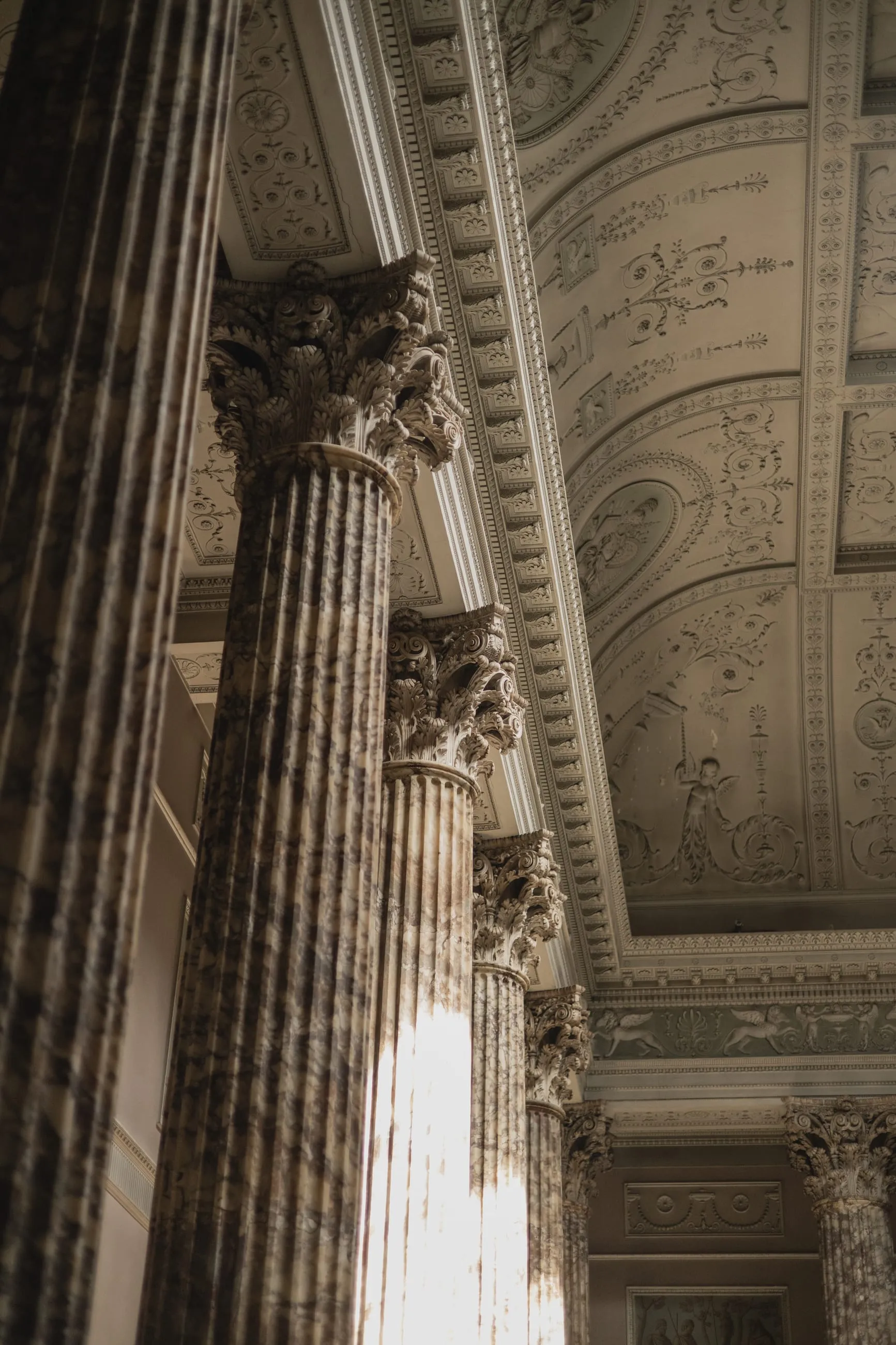 Marble column rising into soft window light