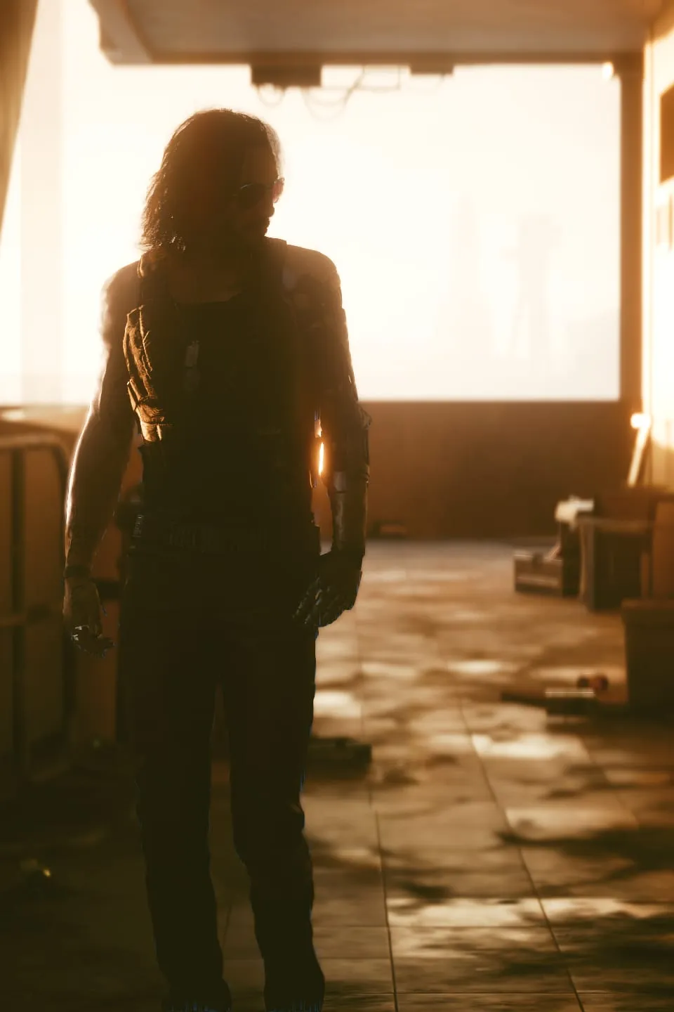 Long-haired man silhouetted against a blown-out window