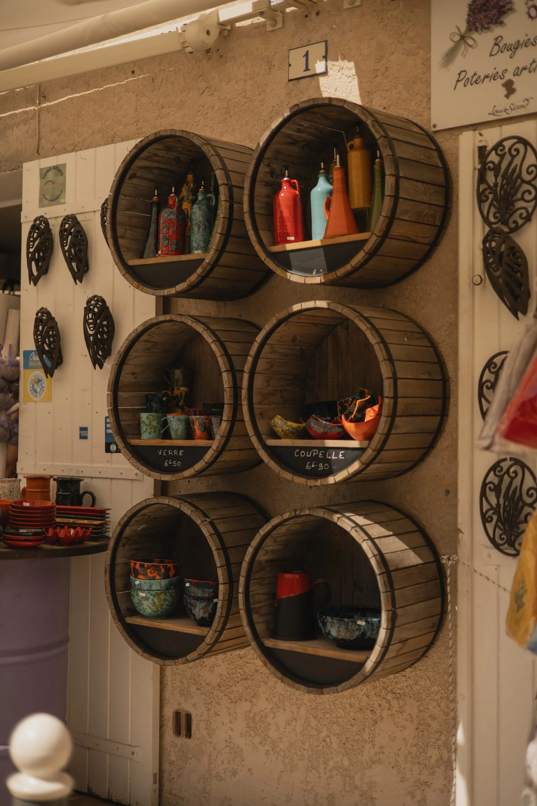 Round barrel-end shelves on a shop wall
