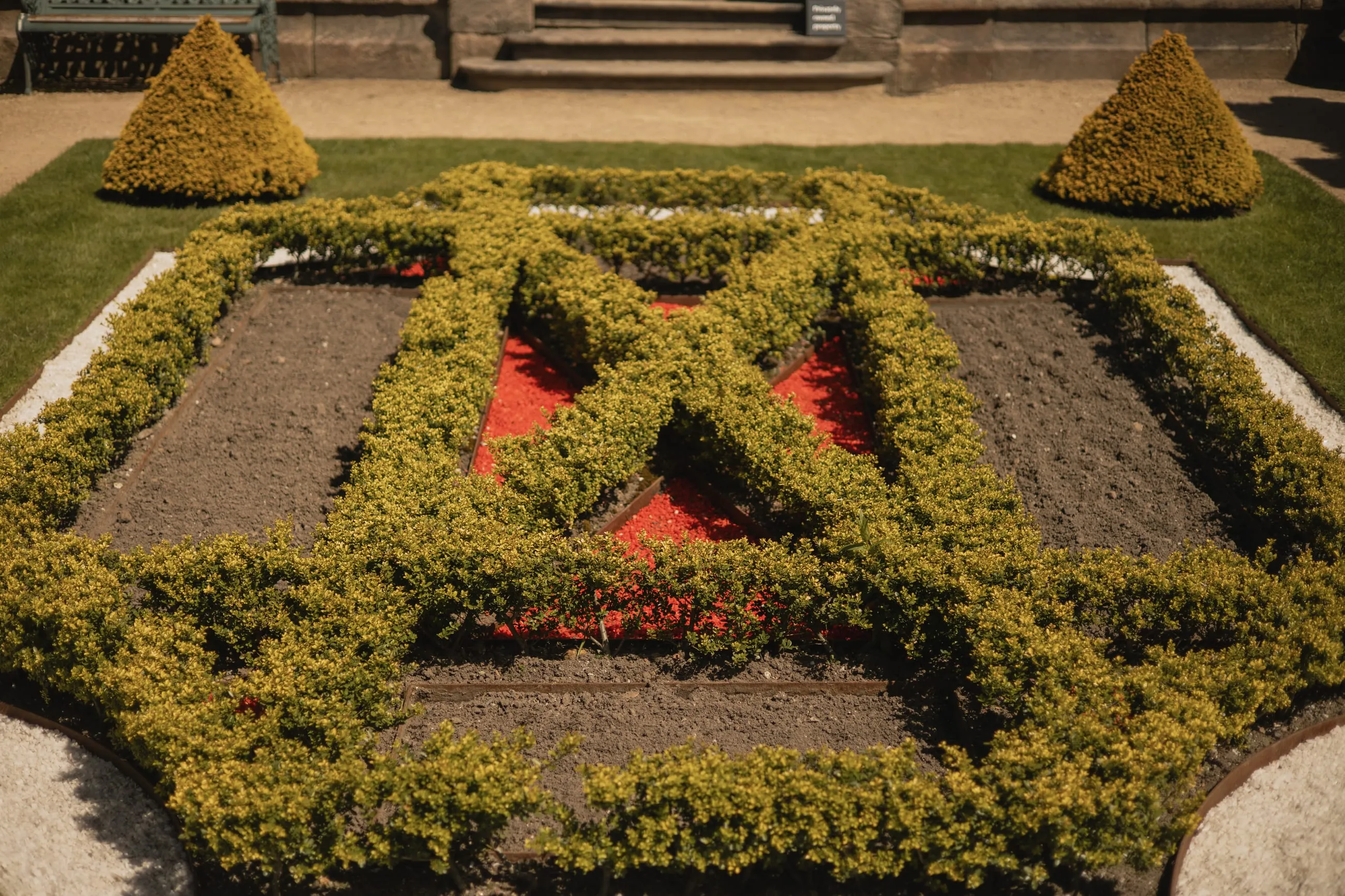 Box parterre with red bedding plants