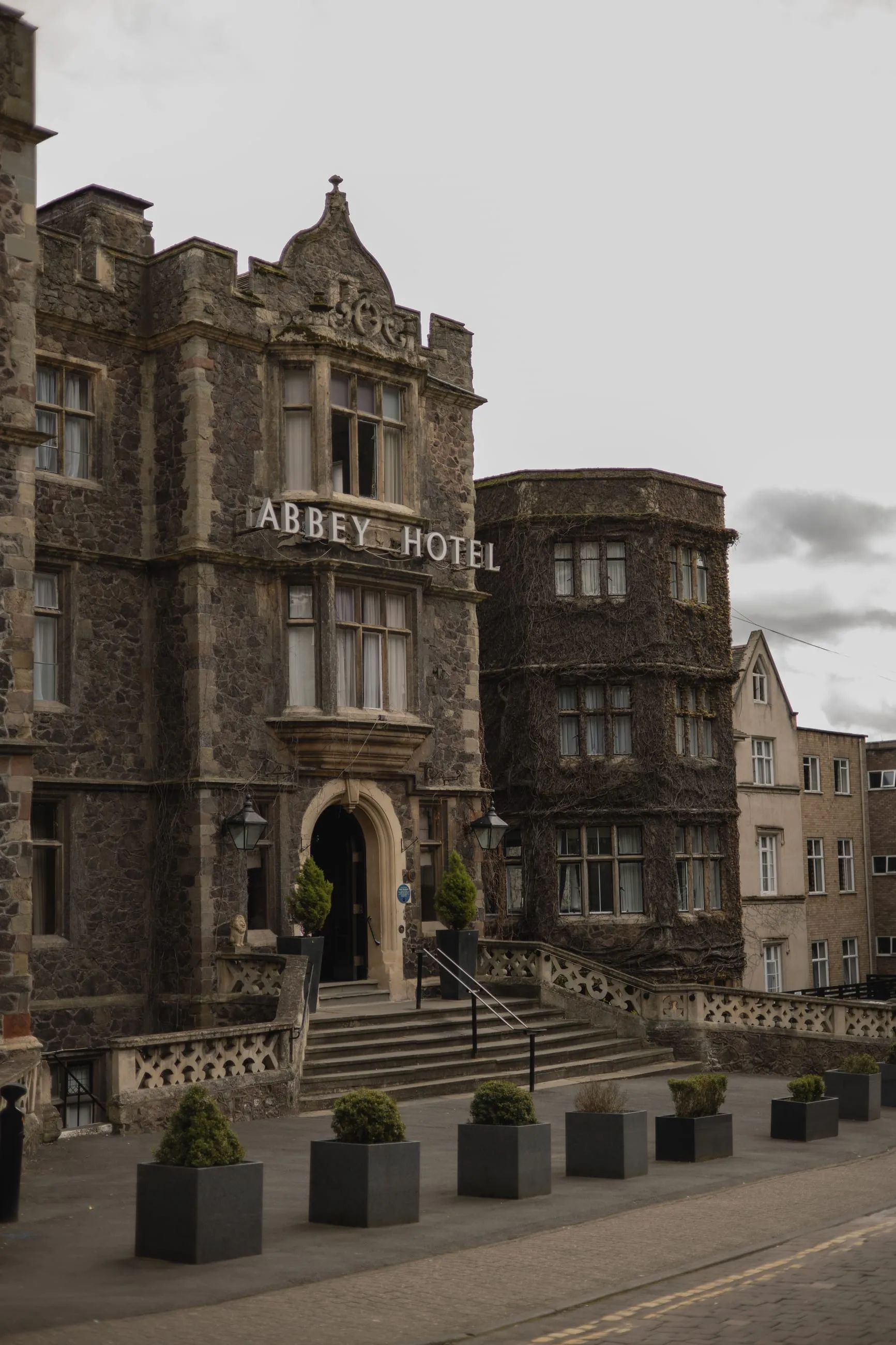 Gothic stone hotel facade with turret