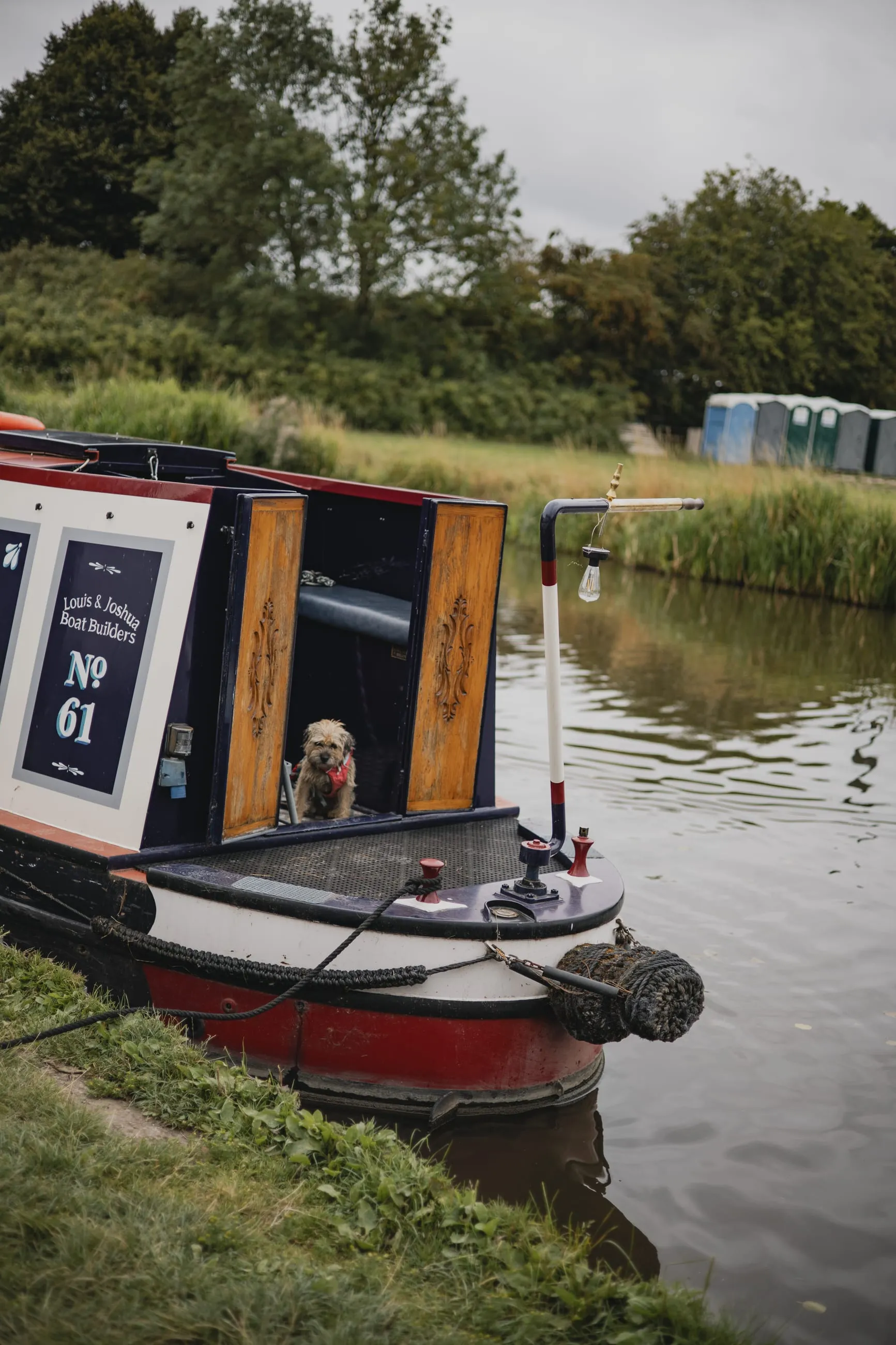 Narrowboat moored on a green canal