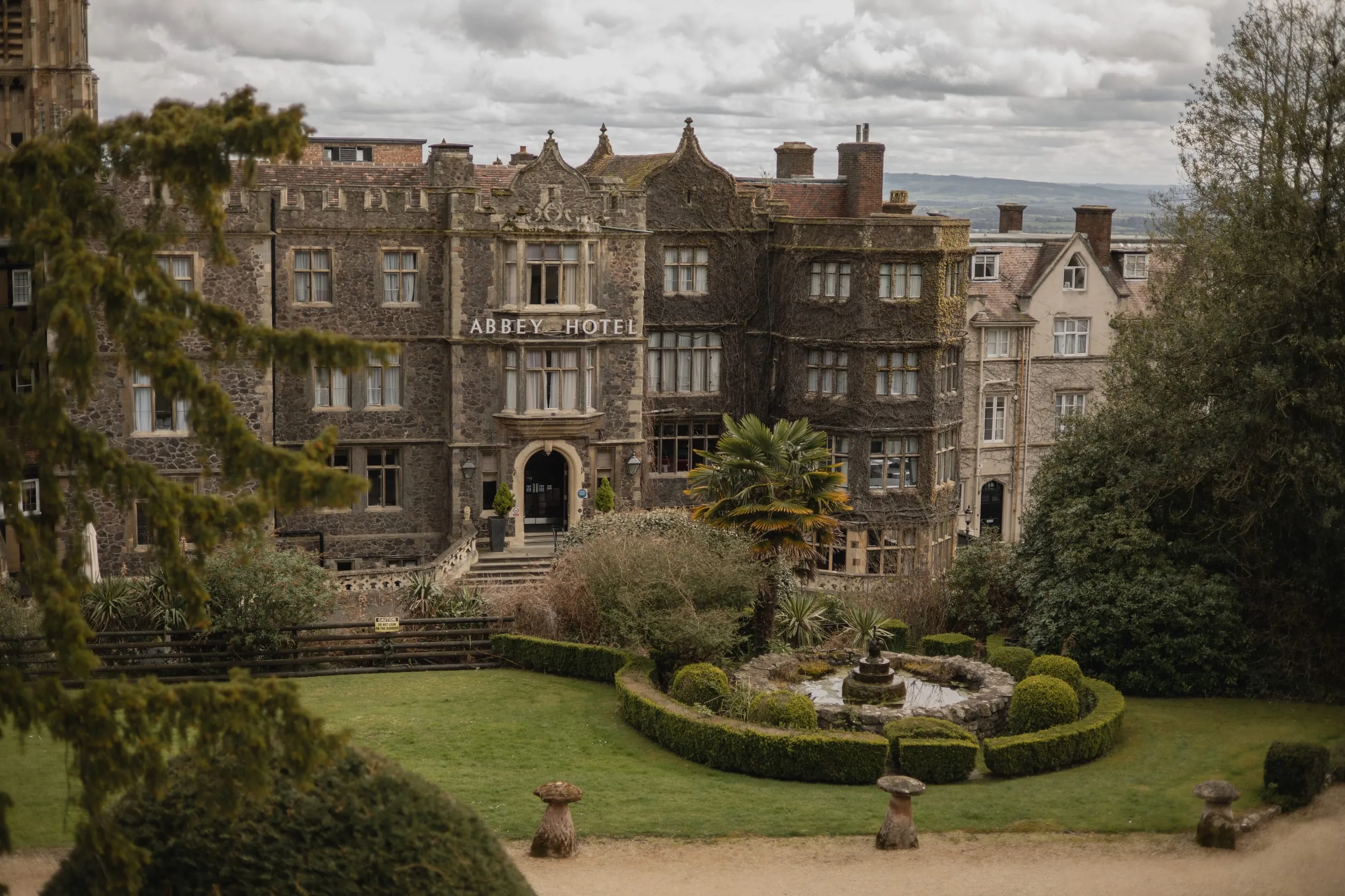Gothic hotel above a formal garden and fountain