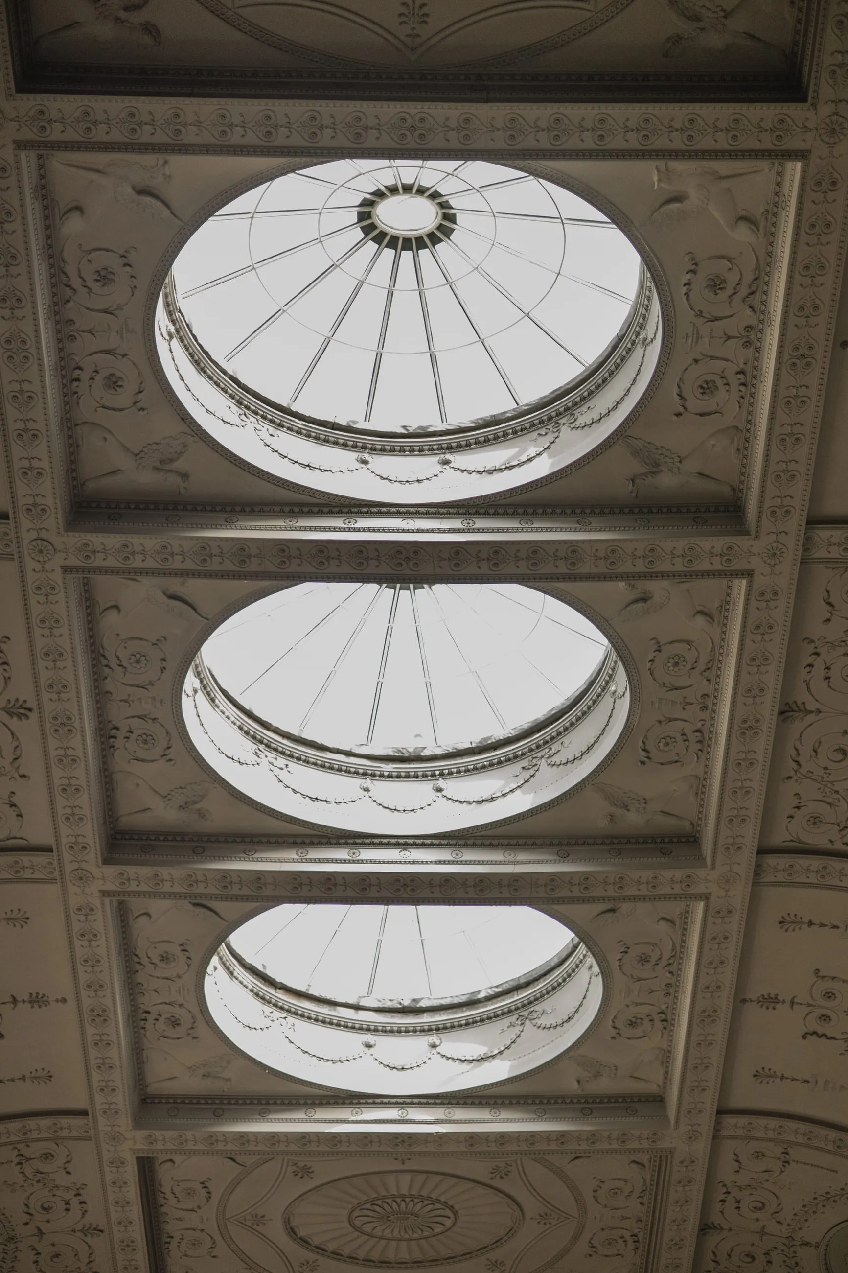 Three oval skylights in a white ceiling