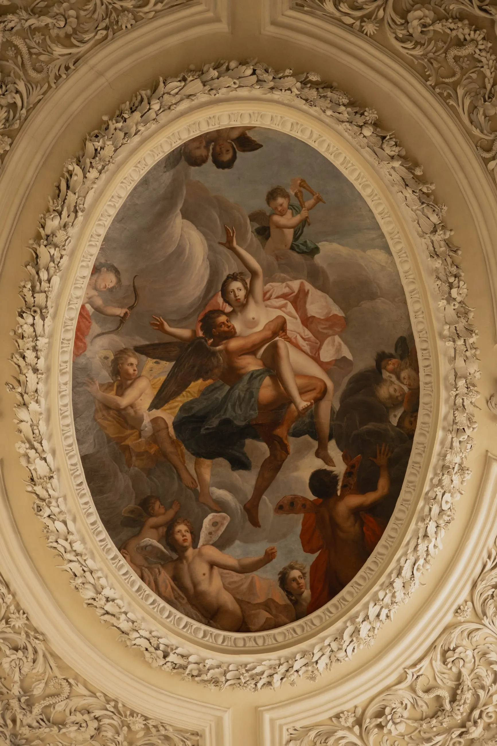 Oval ceiling painting in a carved plaster frame