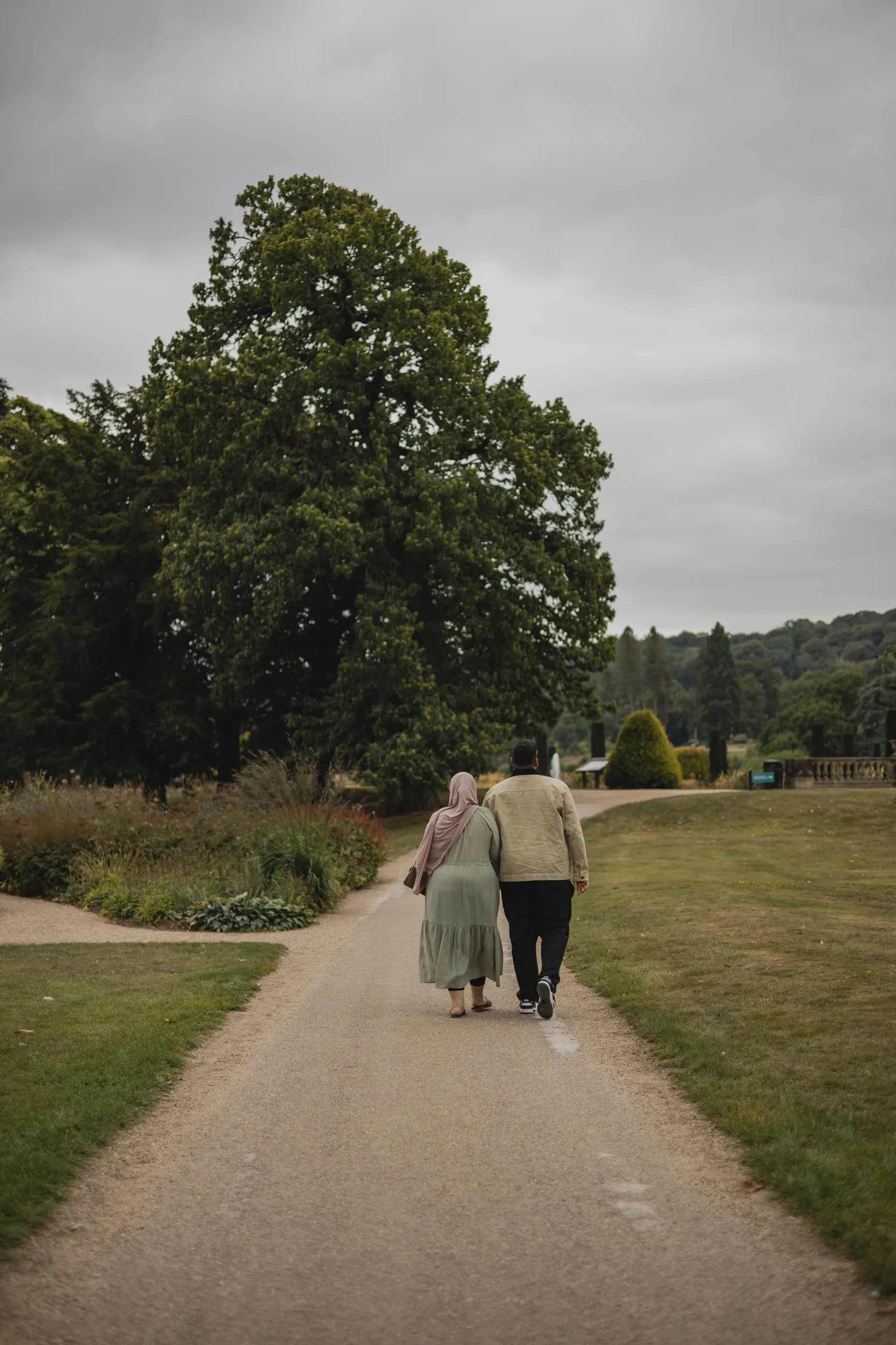 Older couple walking down a garden path