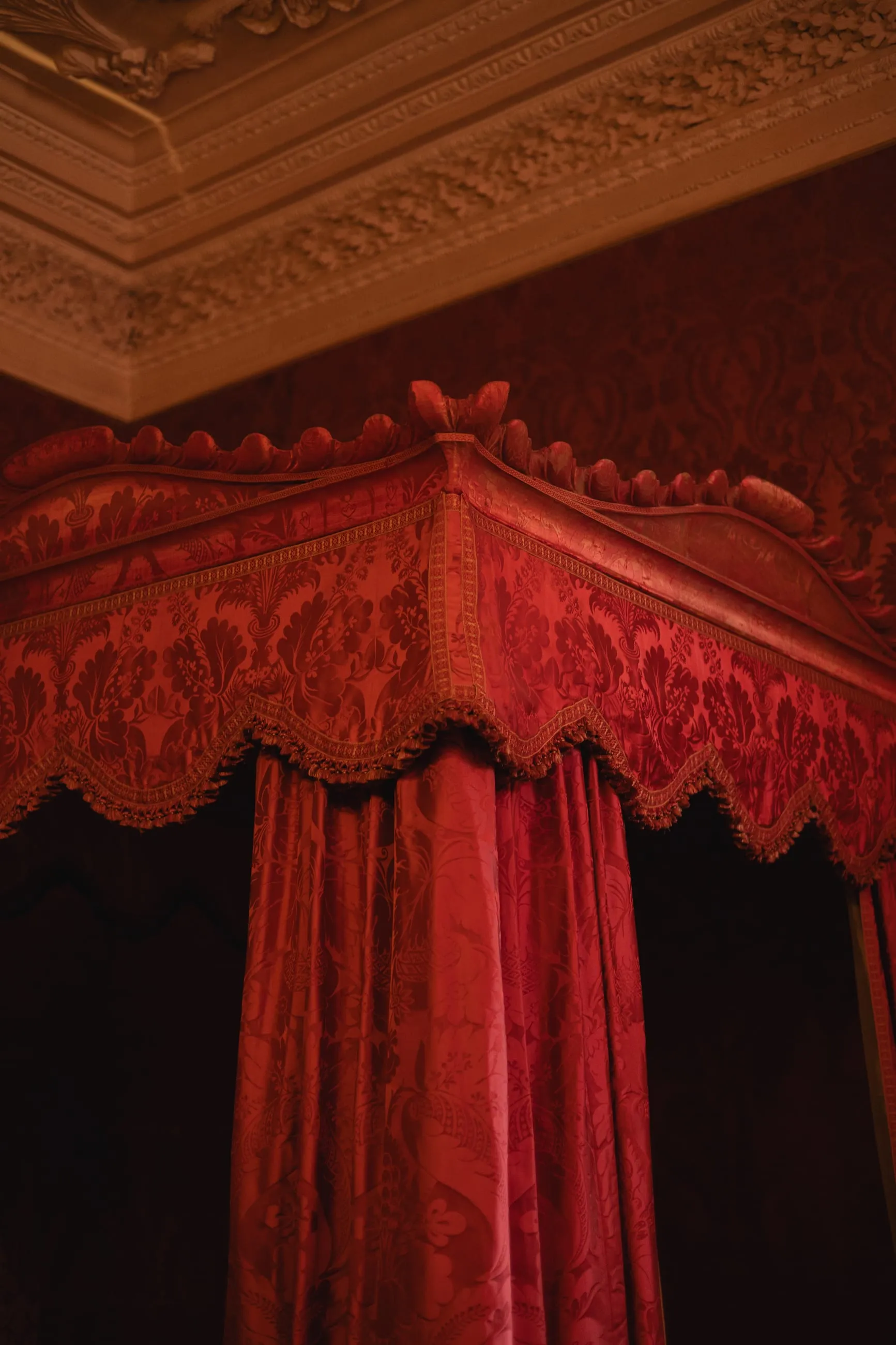 Red velvet canopy of a state bed