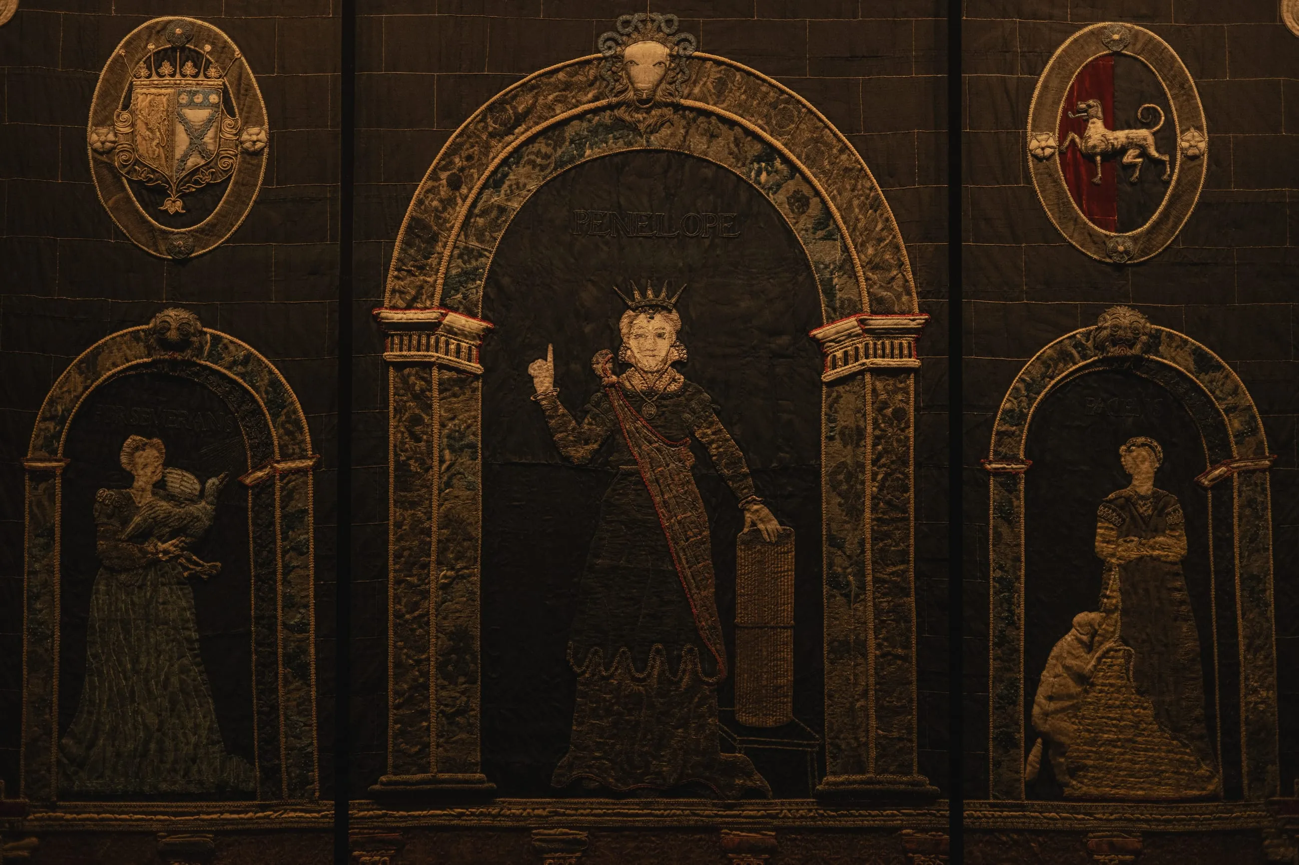 Painted panel of figures under carved arches