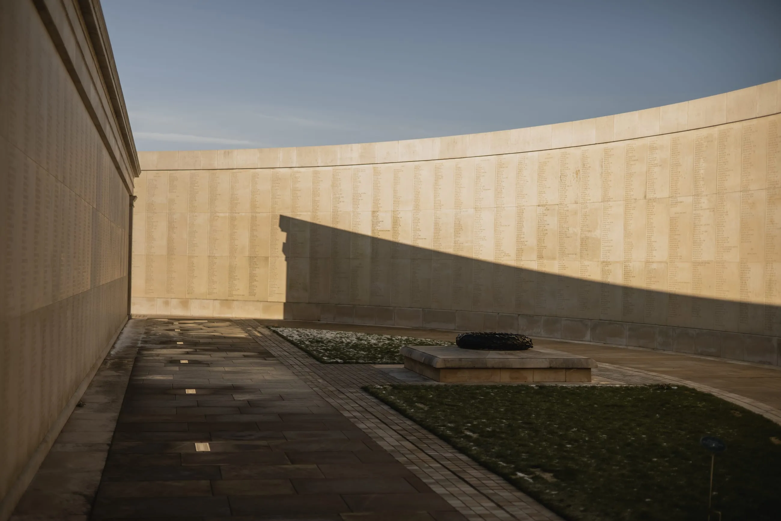 Curved memorial walls in low winter light