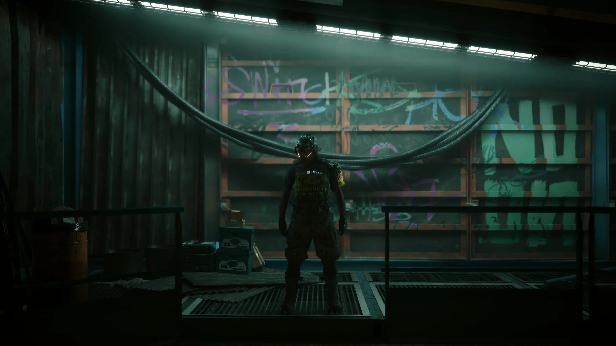 Small figure in a cavernous green-lit warehouse